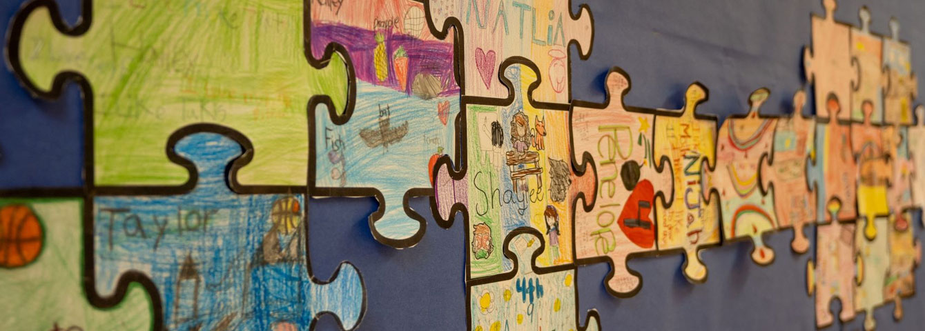 Wall art from students shaped like puzzle pieces.