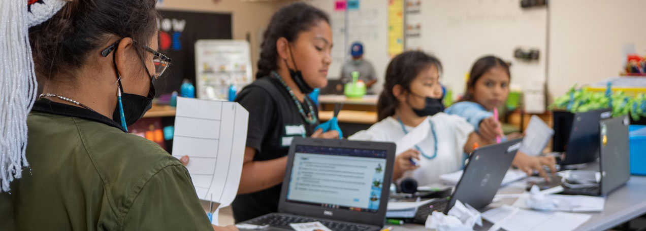 Students in the classroom doing digital learning with laptops. 