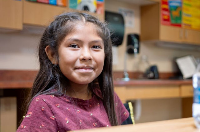 Female student smiling at the camera.