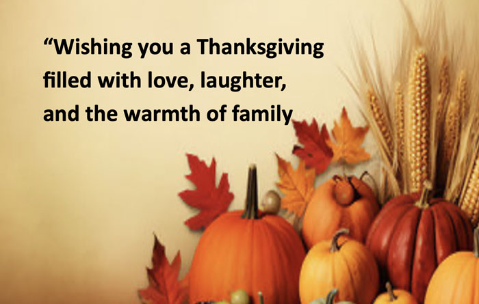 Decorative image with pumpkins, leaves and corn with the words "Wishing you a Thanksgiving filled with love, laughter, and the warmth of family"